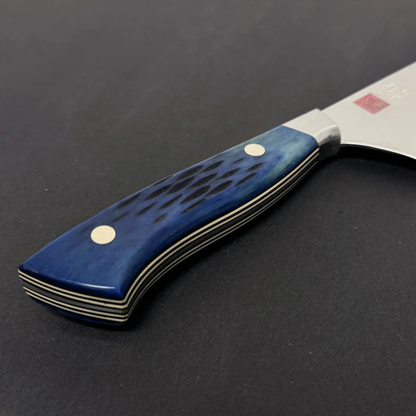 Close-up of blue jigged bone handle on chef knife