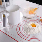 Battery powered flour sifter distributing fine flour into a mixing bowl during homemade baking preparation.