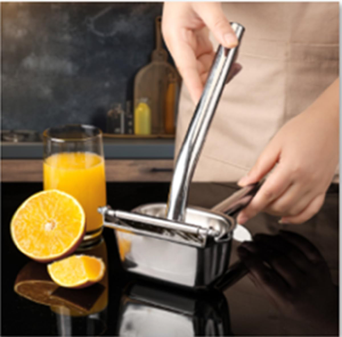 : Handheld stainless steel lemon squeezer detail view