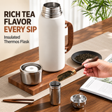 Reusable white insulated water bottle with stainless steel cup lid and stylish wooden handle for hot and cold drinks.